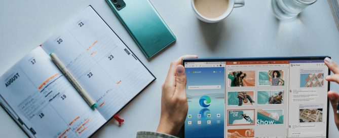 person using Windows 11 computer beside white ceramic mug on white table