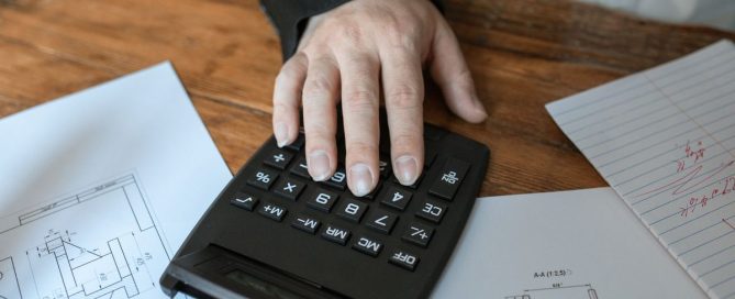 Business owner planning a year-end budget on a laptop
