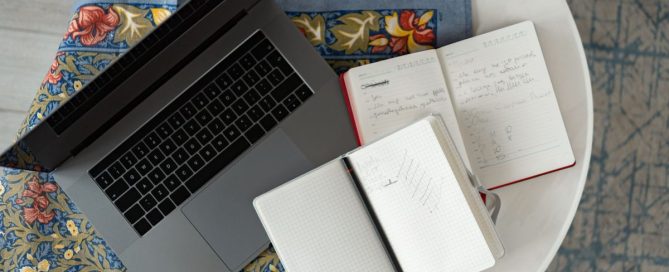 Business owner writing an IT to-do list at a desk