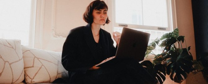 Person working on a laptop at a home office desk