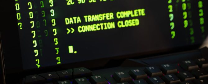 A locked filing cabinet beside a laptop holding customer records